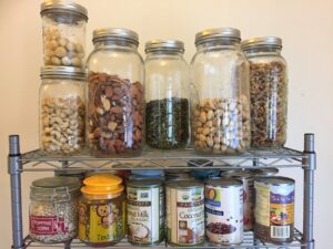 Section of pantry with nuts, dry legumes, and canned goods