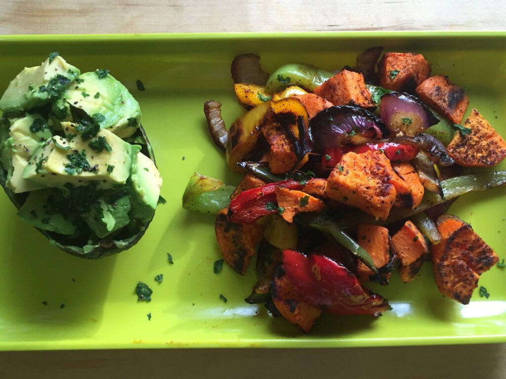 Sweet and Savory breakfast combo: Sauteed sweet potatoes with green and red peppers, and purple onions--seasoned with chili powder, pink salt, pepper, garlic powder, and onion powder. Paired with a half of avocado.