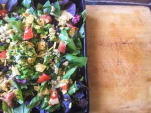 Fiesta Burrito Salad with Cheesy Chipotle Lime dressing recipe courtesy of the Vegan Fit Carter blog